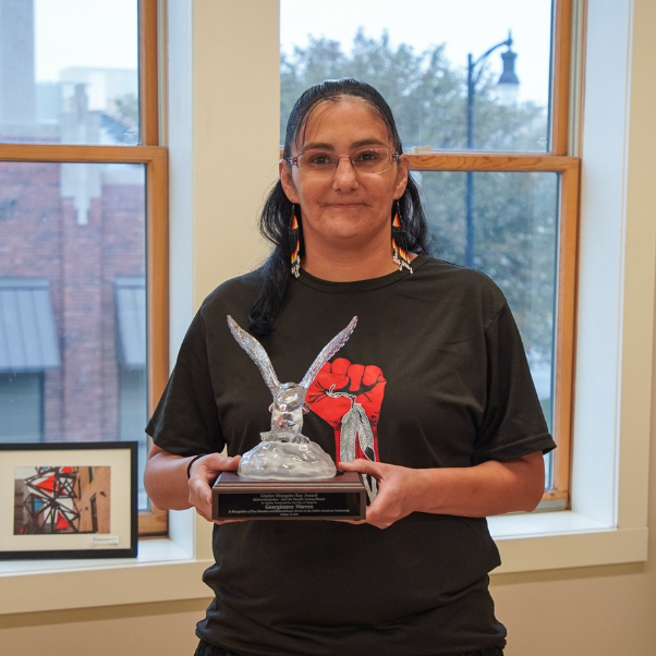 Georgianna Warren stands holding her Gladys Ray Indigenous Peoples Day Award.