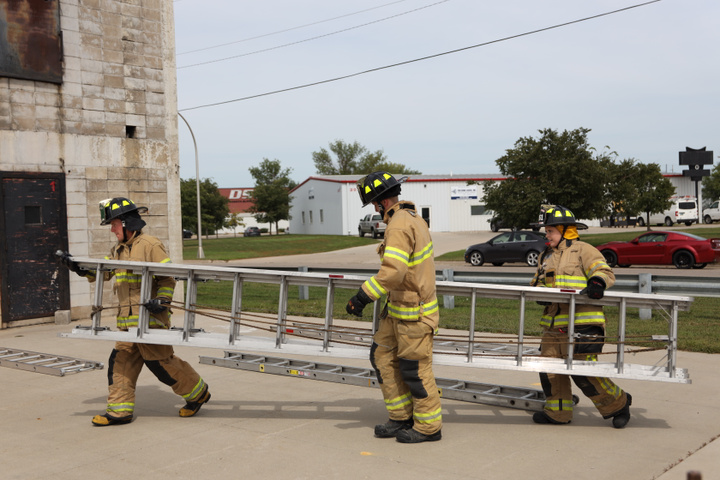 Fargo Firefighters Carrying a Ladder
