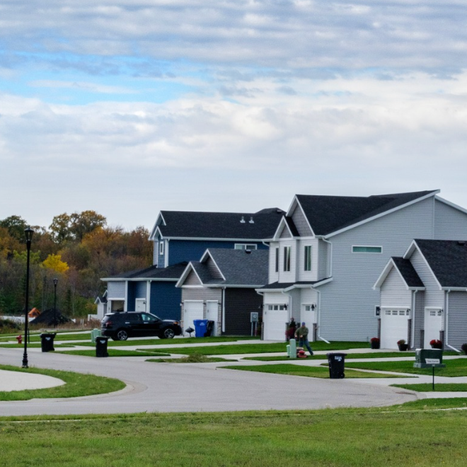 Two houses along on a street.