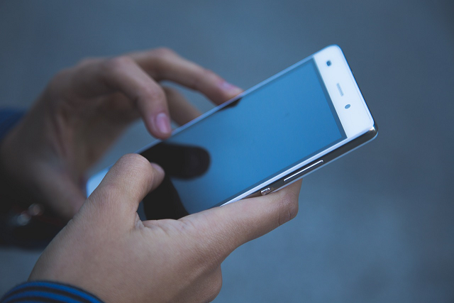 Hands holding a cell phone