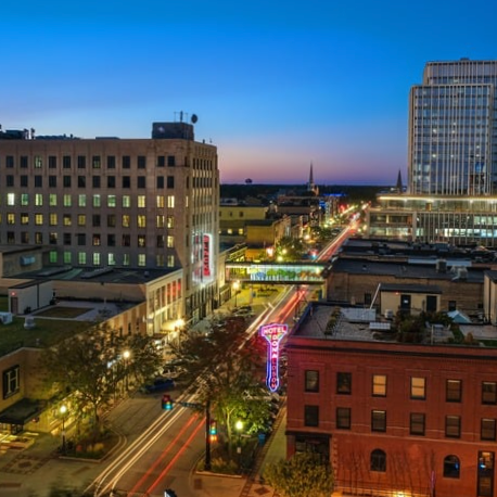 A view of downtown Fargo showing the Black building, Hodo building and RDO tower along Broadway in the evening.